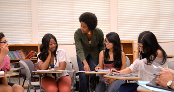 Teacher helping students in classroom