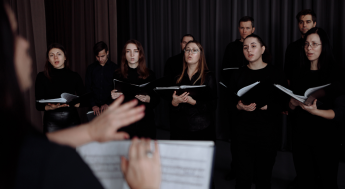 Choir conductor directing choir singers