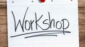 Paper with the word Workshop pinned to a wall