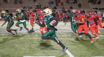 Monarch's Football player running with ball