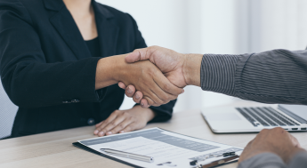 Job candidate shaking hands with employer at job interview