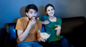 Students watching a movie eating popcorn