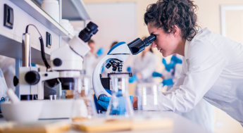 Female lab technician looking in a microscope