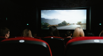 People watching a movie in a dark movie theater