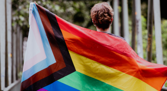 Person holding a LGBTQIA Flag