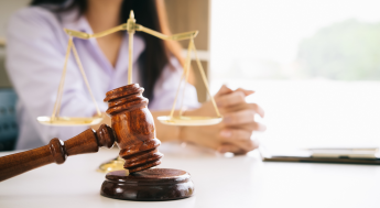Female lawyer with a judge's gavel in front