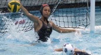 Women's Water Polo player blocking the ball