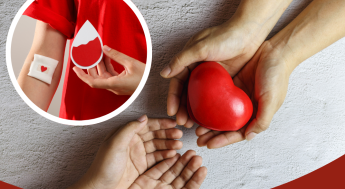 Person that donated blood. Hands passing a red heart.
