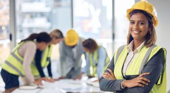 Construction workers in hard hats and yellow vests