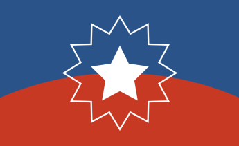 Juneteenth Flag with blue on top and red on bottom with a white star surrounded by a white starburst in the center of flag