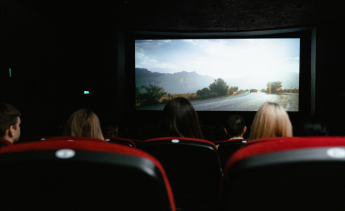 People watching a movie in a dark movie theater