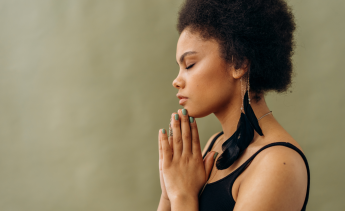 Black female calm doing a yoga pose