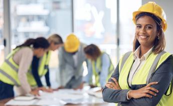 Construction workers in hard hats and yellow vests