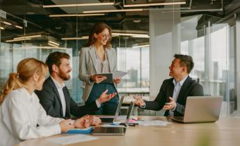 Diverse group of employees talking in a conference room