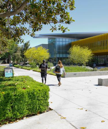 Two Students Walking on Campus