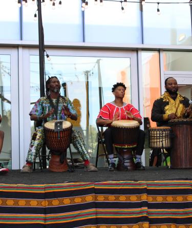 People playing the drums on stage