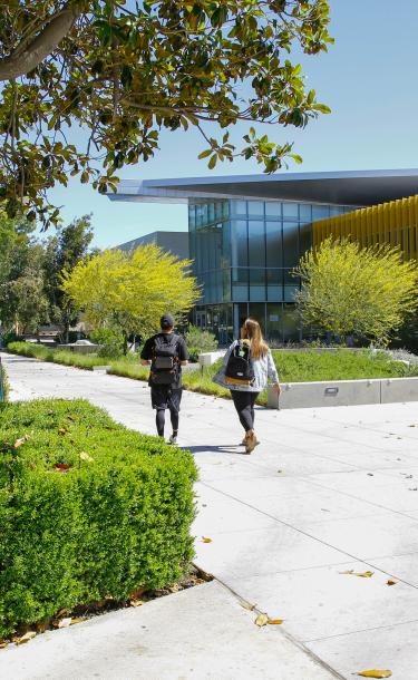 Two students walking on campus