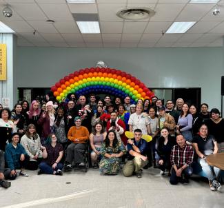 Pride students posing as a group for the annual Holigay Mixer 