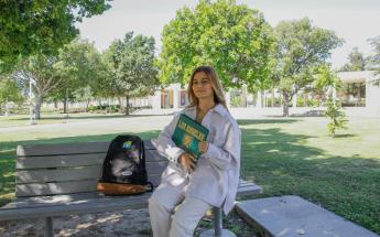 Student Seated Holding a Book
