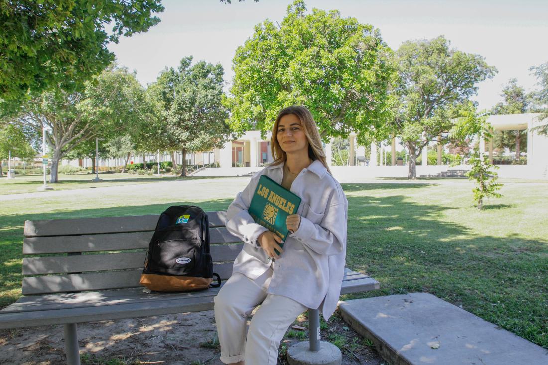 Student Seated Holding a Book