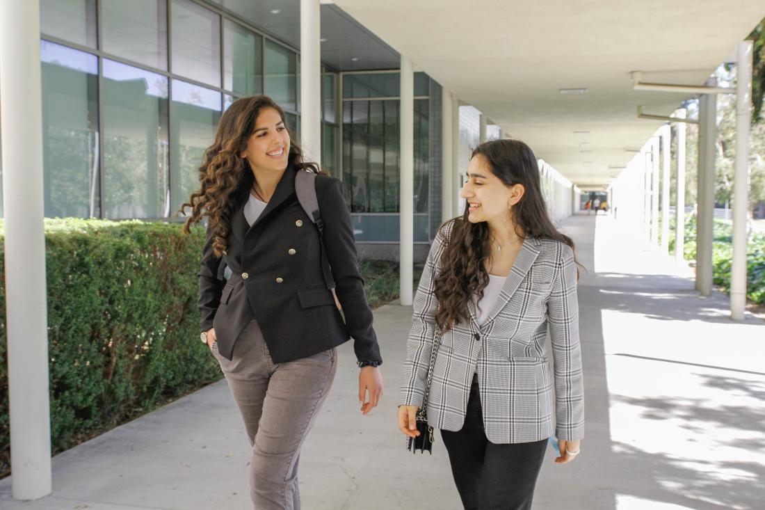 Two Students Waling in a Hall