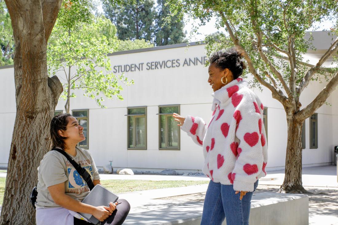 Two Students Female Talking on Campus