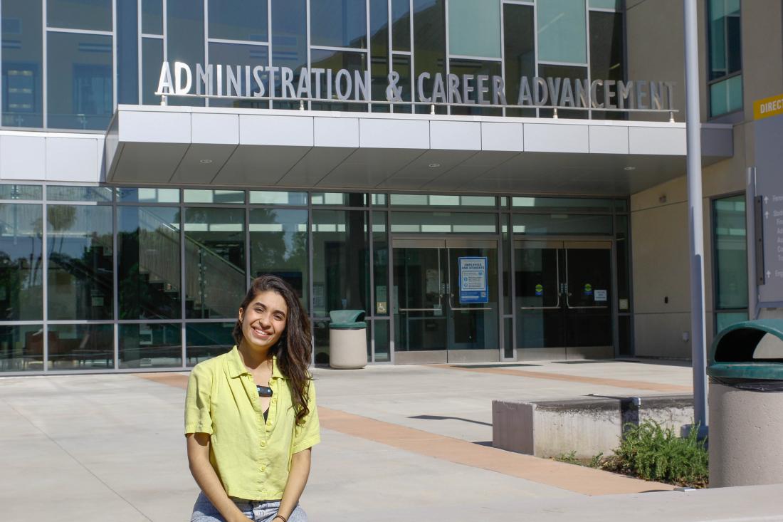 Student in Front of Administration Building
