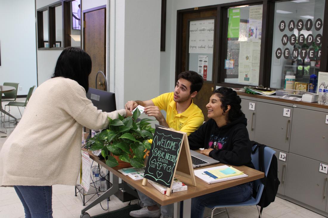 Person handing and pointing at a flyer