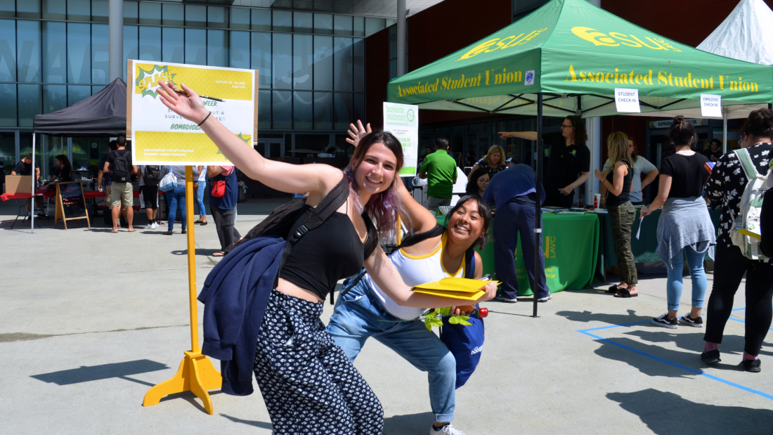 Two female students happily posing for the camera