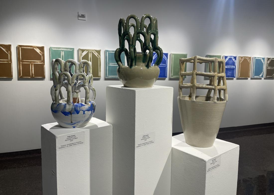 three ceramic vessels on pedestals