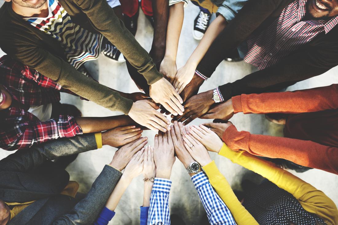 a number of hands in a circle overlapping each other