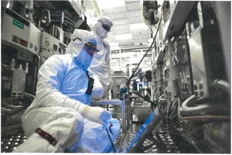 Manufacturing Technician working in front of system