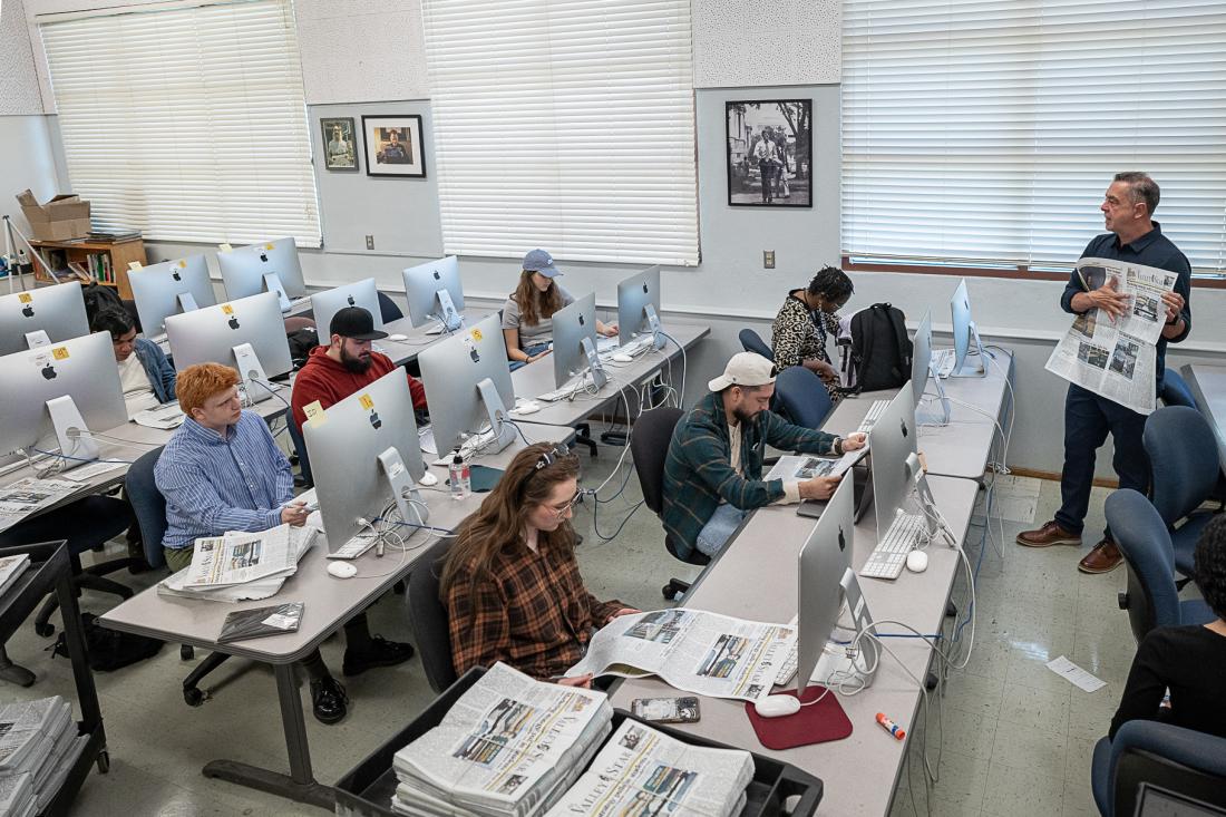 Journalism students with instructor in the newsroom