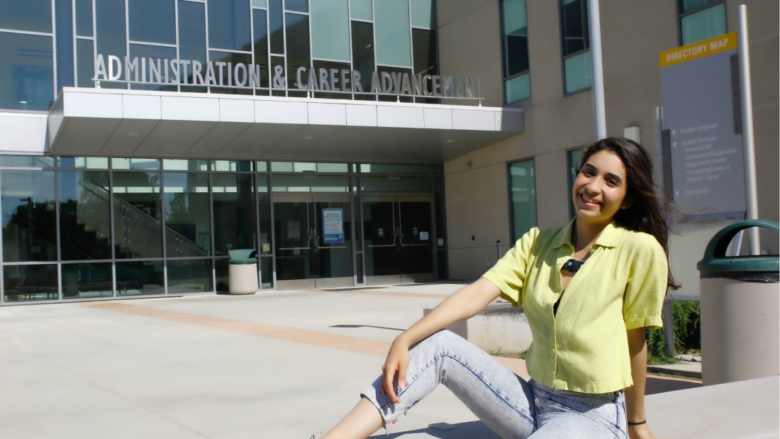 Lorie sitting in front of the Administration & Career Advancement Building