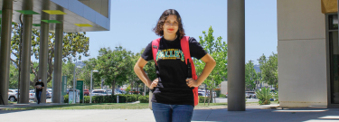 Female student in Valley College shirt with a backpack