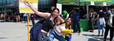 Two happy female students posing in front of the camera