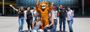 LAVC Mascot with happy students in front of the Student Union