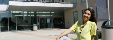 Female student in front of the Administration & Career Advancement building