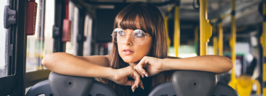 Girl with glasses sitting on the bus