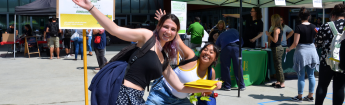 Two happy female students posing in front of the camera