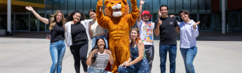 LAVC Mascot with happy students in front of the Student Union