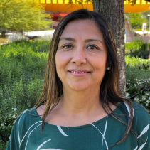 Image of Dean Negrete wearing green top an a tree lined background