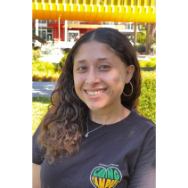 Person wearing black shirt with trees in the background