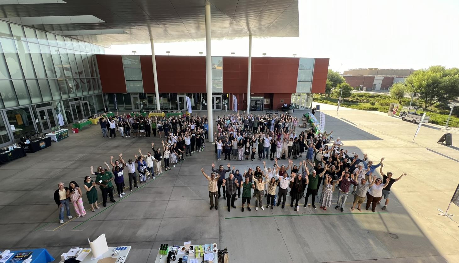 Faculty and staff line up to form a 75