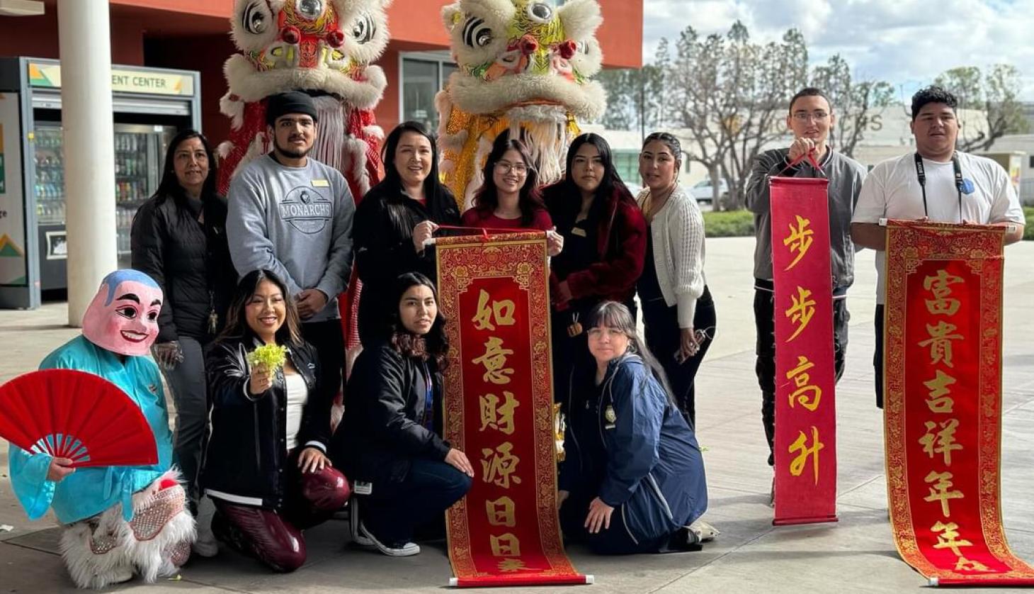 7 people standing by a lunar new year dragon